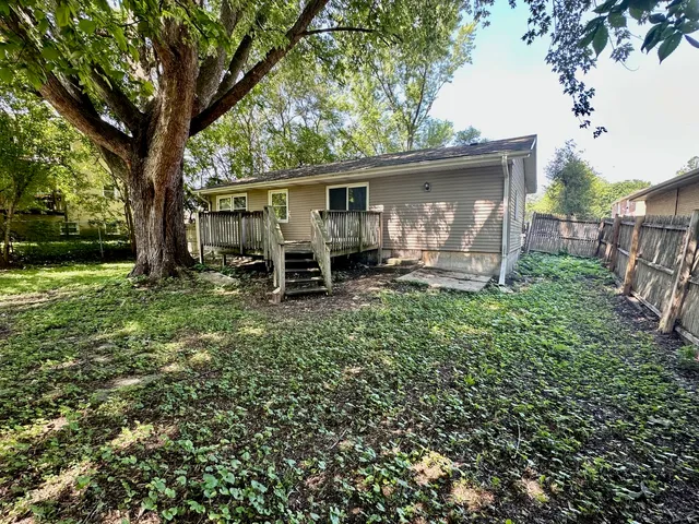 a backyard of a house with yard and outdoor seating