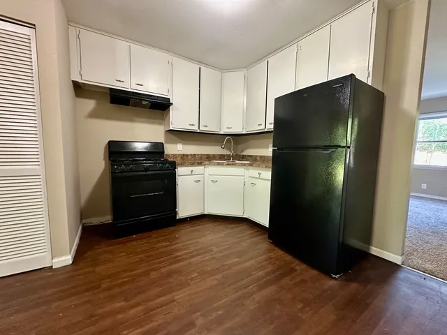 a kitchen with a refrigerator and a stove