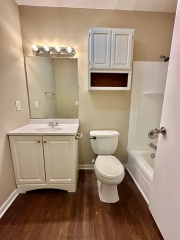 a bathroom with a toilet a sink and bathtub