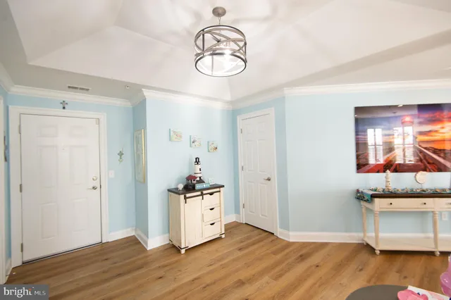 a view of a kitchen with wooden floor and window