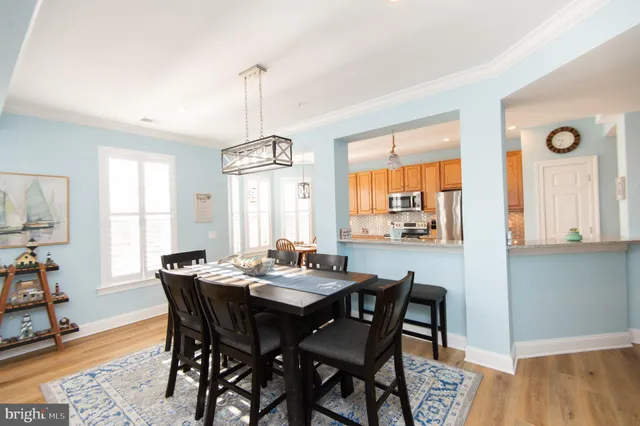 a dining room with furniture window and wooden floor