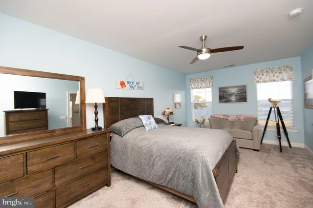 a bedroom with a large bed and a flat screen tv