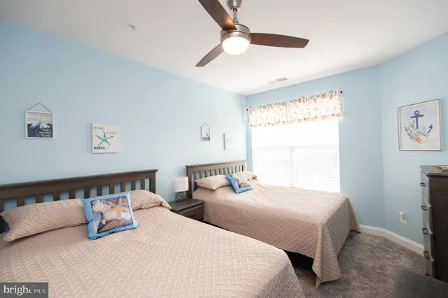 a bedroom with two beds and a window