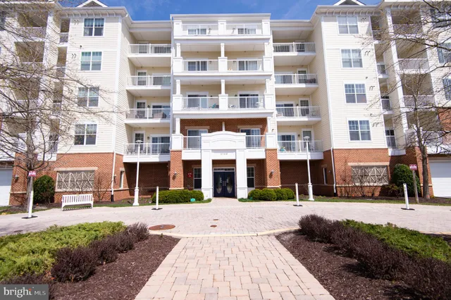 a front view of a building with a garden