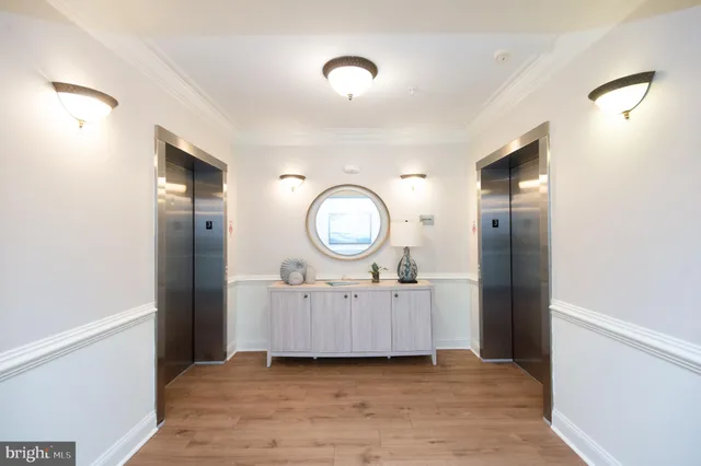 a view of a livingroom with furniture wooden floor and mirror