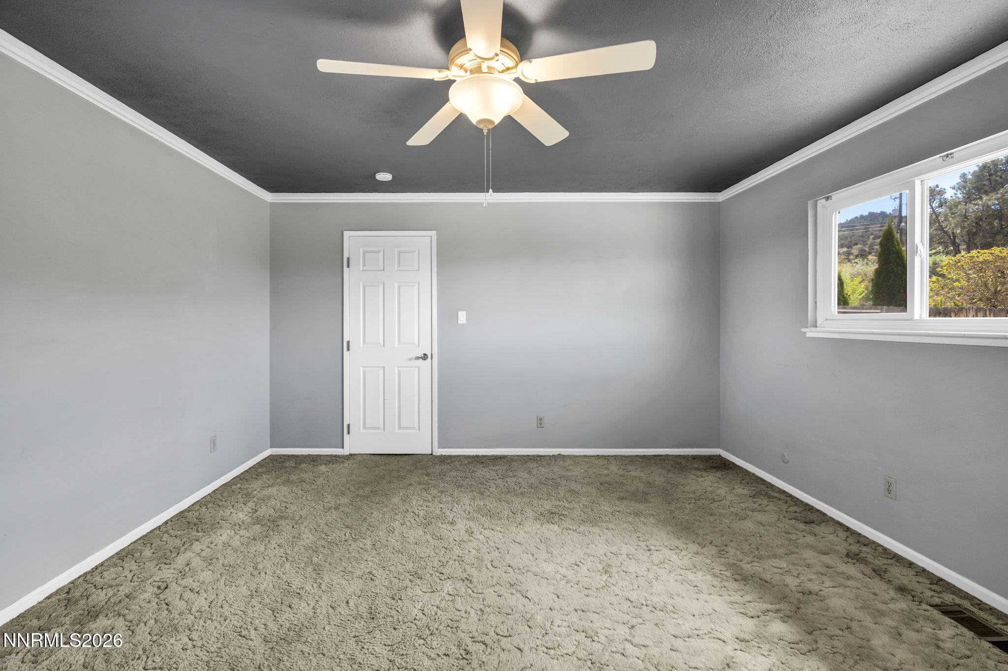 14190 Rim Rock Drive Reno, NV 89521 - Photo 30 of 68 en empty room with windows and ceiling fan