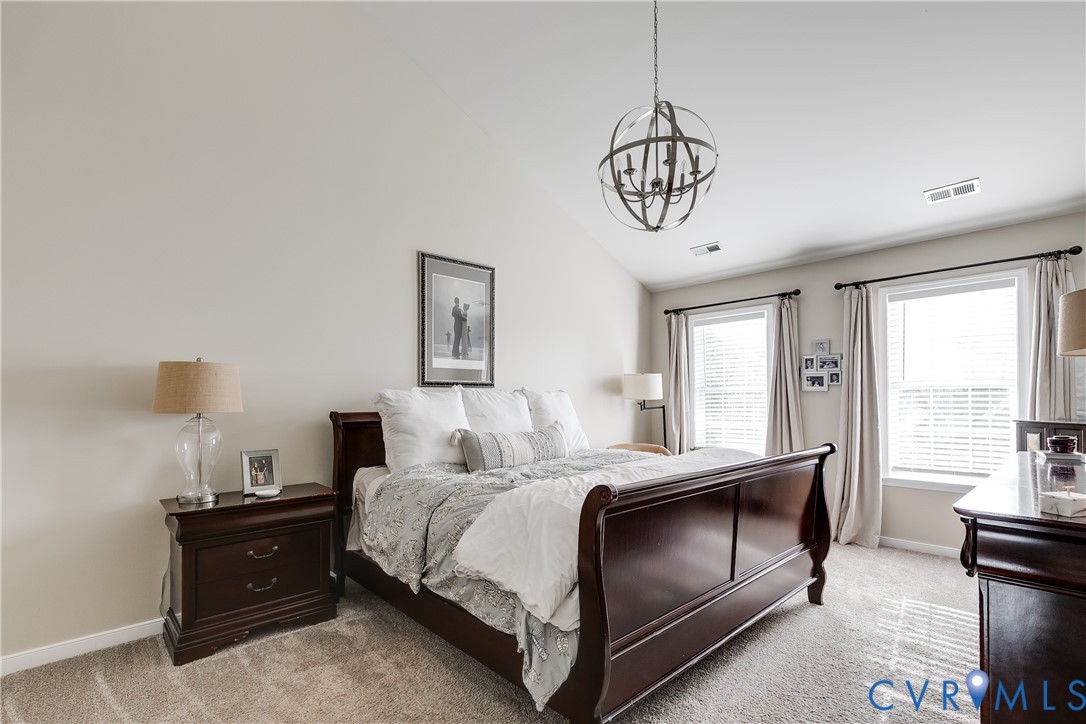 806 Biggin Pond Road Midlothian, VA 23114 - Photo 34 of 50 a bedroom with a bed and window with a chandelier