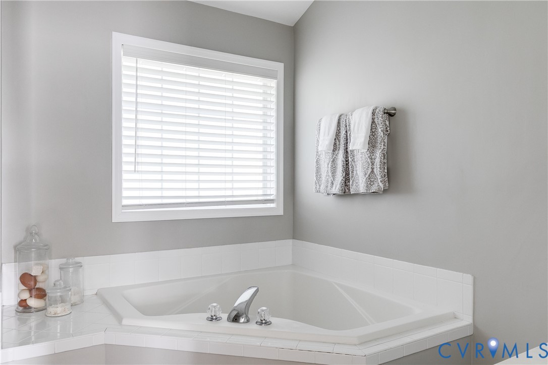 806 Biggin Pond Road Midlothian, VA 23114 - Photo 42 of 50 a white bath tub sitting in a bathroom next to a window