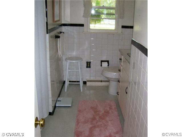 6908 Grubby Road Wilsons, VA 23894 - Photo 11 of 12 a view of a bathroom with a sink and a toilet