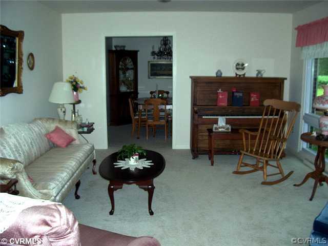 6908 Grubby Road Wilsons, VA 23894 - Photo 5 of 12 a living room with furniture and a fireplace