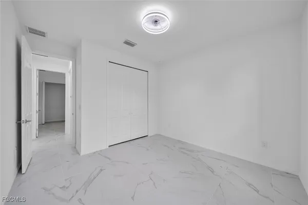 an empty room with a washer and dryer