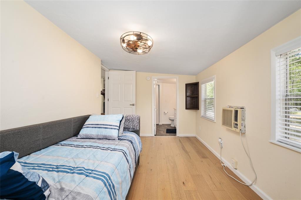 7870 Southwest 25th Place Bell, FL 32619 - Photo 79 of 99 a bedroom with a bed and a chandelier