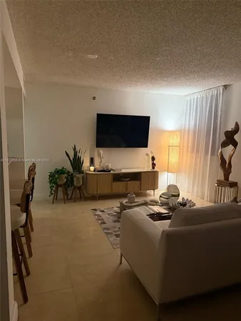 a living room with furniture window and a flat screen tv