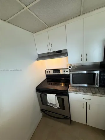 a kitchen that has a sink and a stove