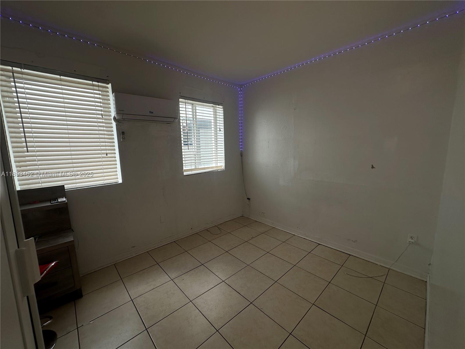 1021 Northwest 3rd Street, Unit 305 Miami, FL 33128 - Photo 18 of 22 an empty room with windows
