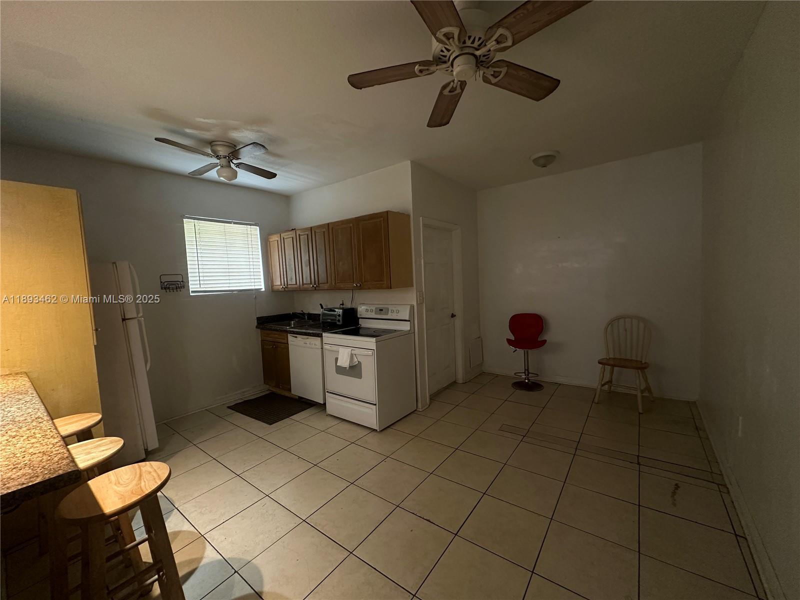 1021 Northwest 3rd Street, Unit 305 Miami, FL 33128 - Photo 20 of 22 a kitchen with a cabinets and appliances