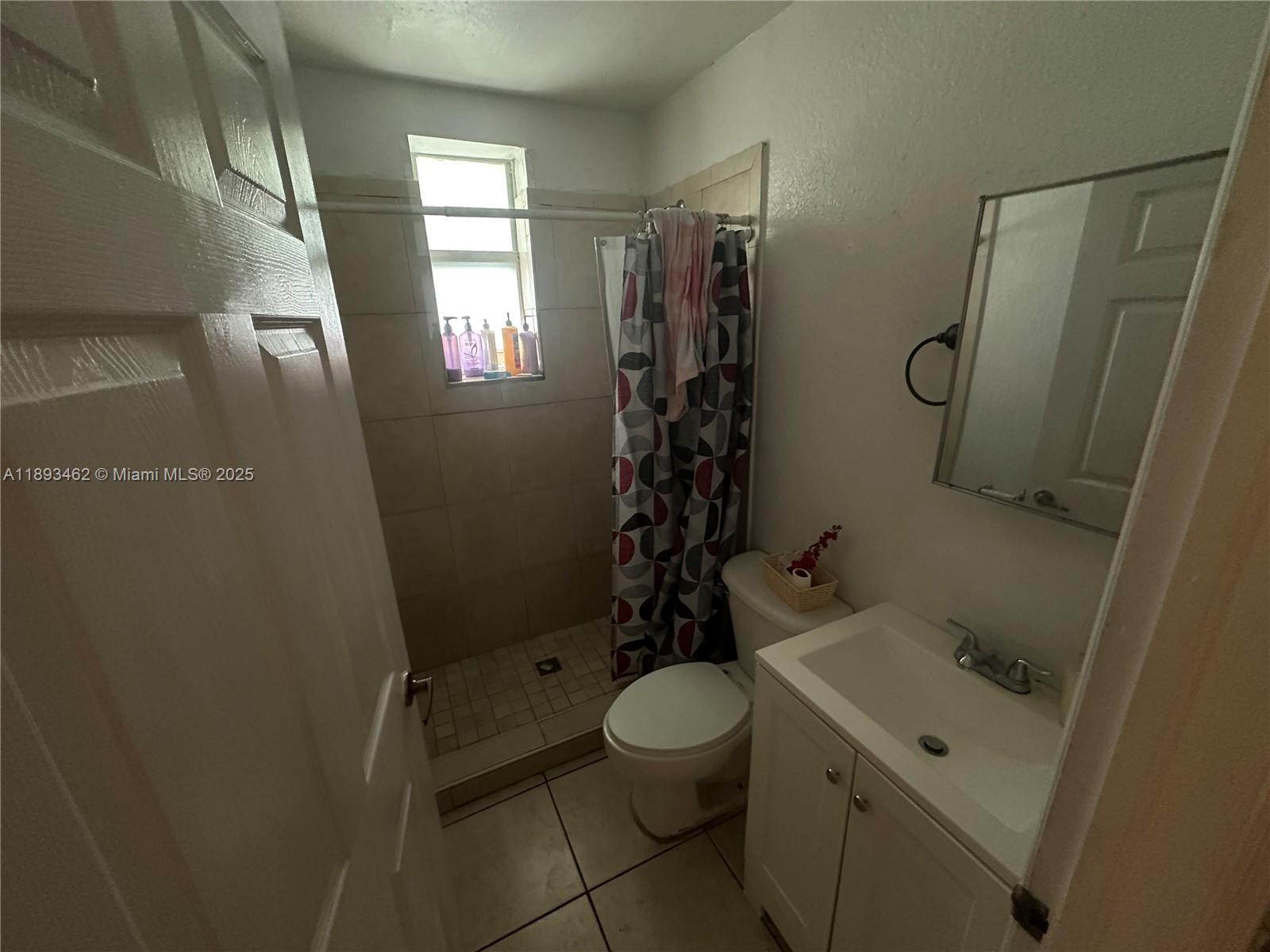 1021 Northwest 3rd Street, Unit 305 Miami, FL 33128 - Photo 21 of 22 a bathroom with a toilet sink and shower