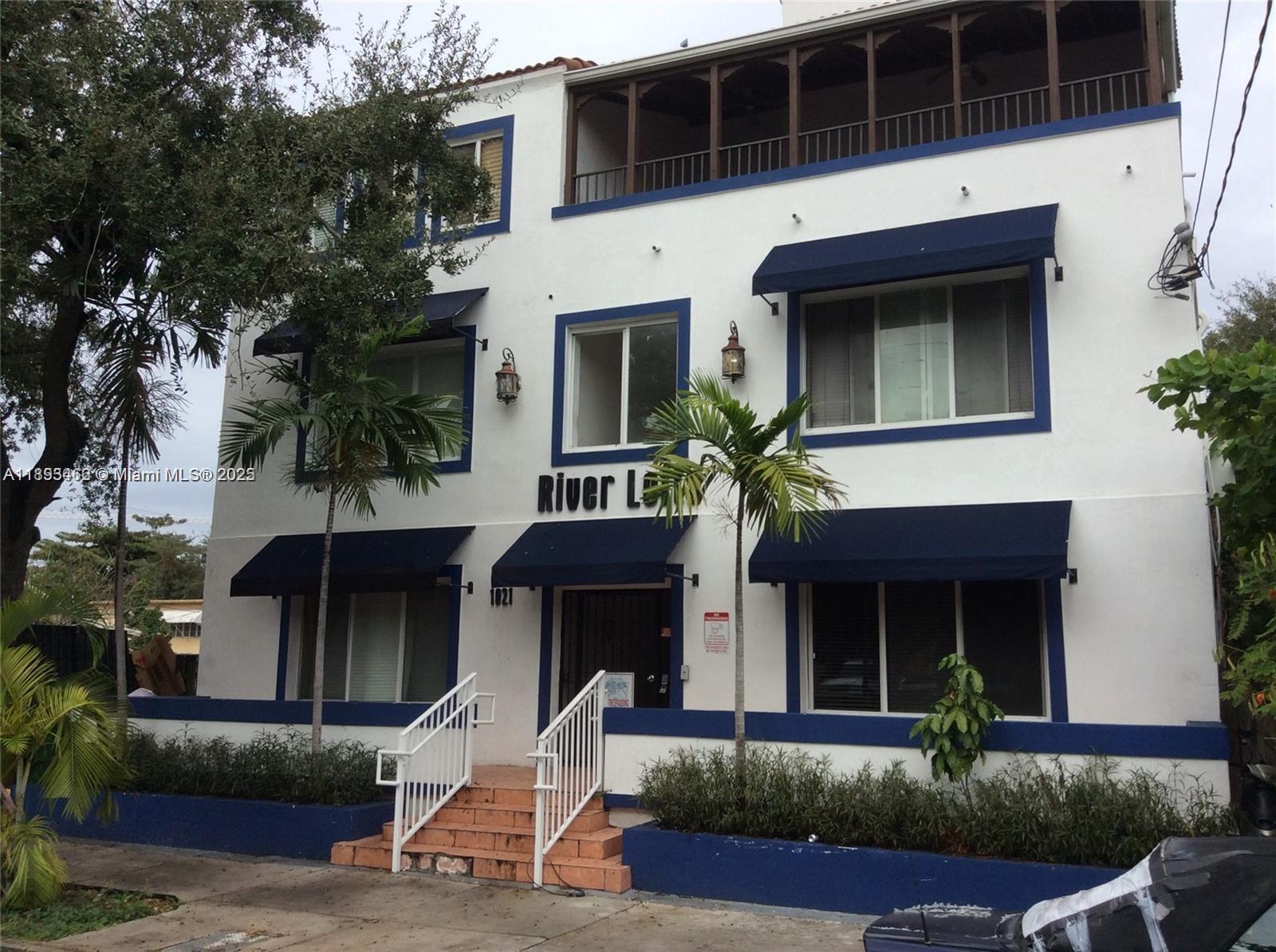 1021 Northwest 3rd Street, Unit 305 Miami, FL 33128 - Photo 8 of 22 a front view of a house with garden