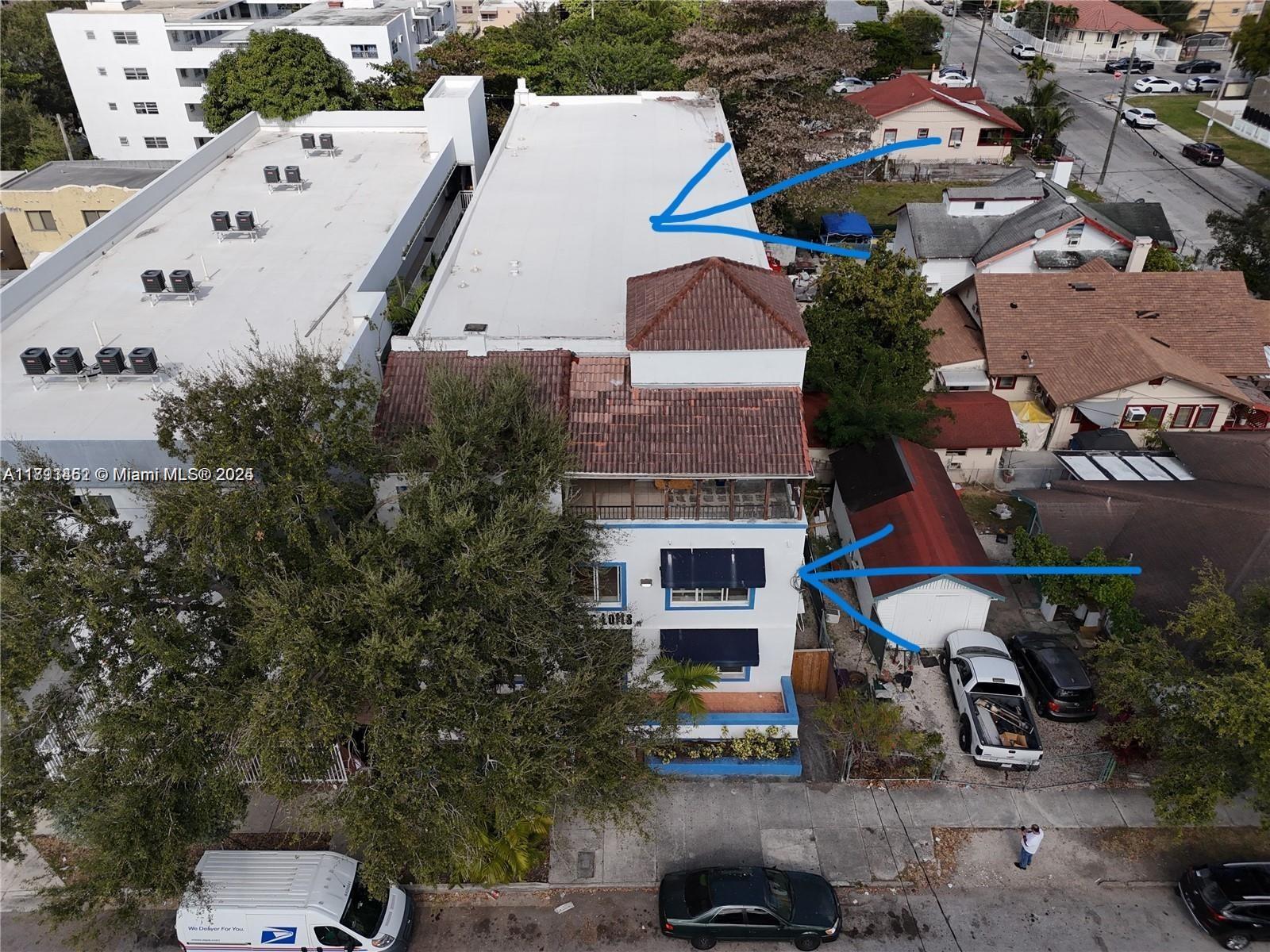 1021 Northwest 3rd Street, Unit 305 Miami, FL 33128 - Photo 10 of 22 an aerial view of a house with a yard and seating area