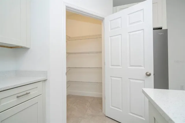 a large kitchen with cabinets and stainless steel appliances