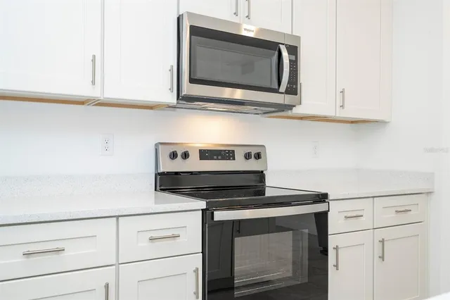 a kitchen with cabinets and stainless steel appliances