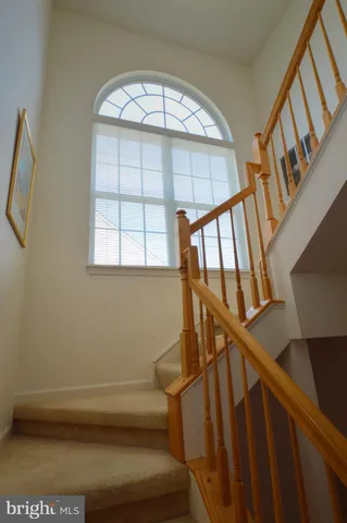 a view of staircase with white walls and a window