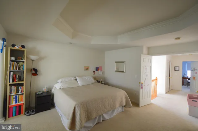 a bedroom with a bed and a book shelf