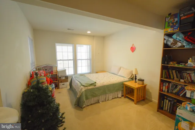 a bed room with a bed and a book shelf