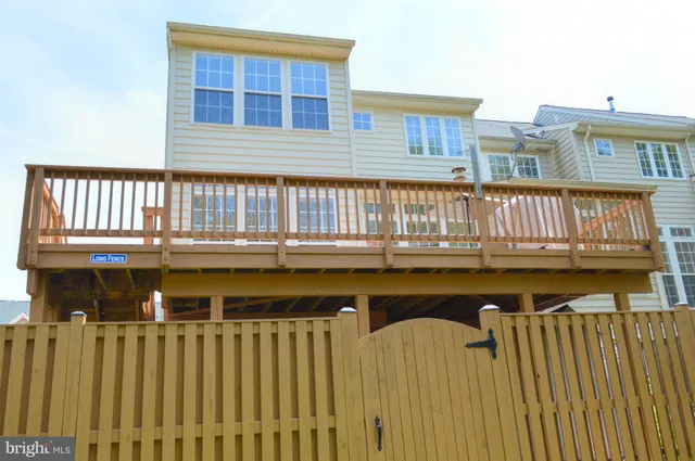 a view of a yard with wooden fence