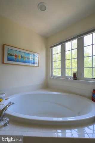 a bath tub sitting next to a window