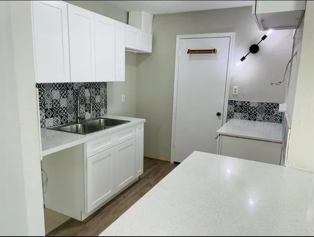 a kitchen with white cabinets and white appliances