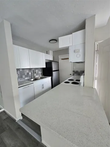 a white toilet sitting next to a bath tub