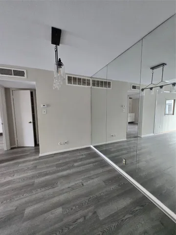 a view of a hallway with wooden door