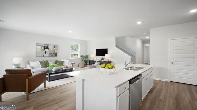 a living room with kitchen island furniture and a wooden floor