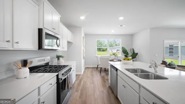 a kitchen that has a sink and a stove
