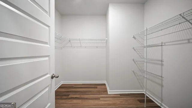 a view of walk in closet with empty racks