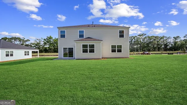 a view of a house with a backyard