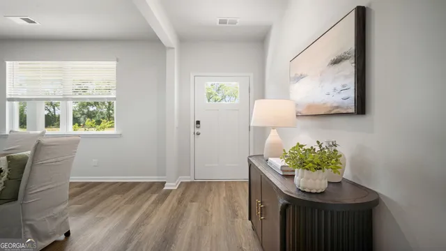 a view of a room with wooden floor and window
