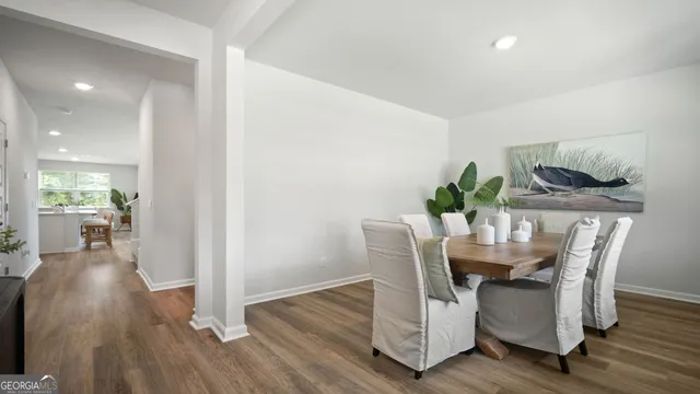 a view of a dining room with furniture and wooden floor