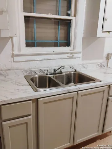 a kitchen with a sink and cabinets