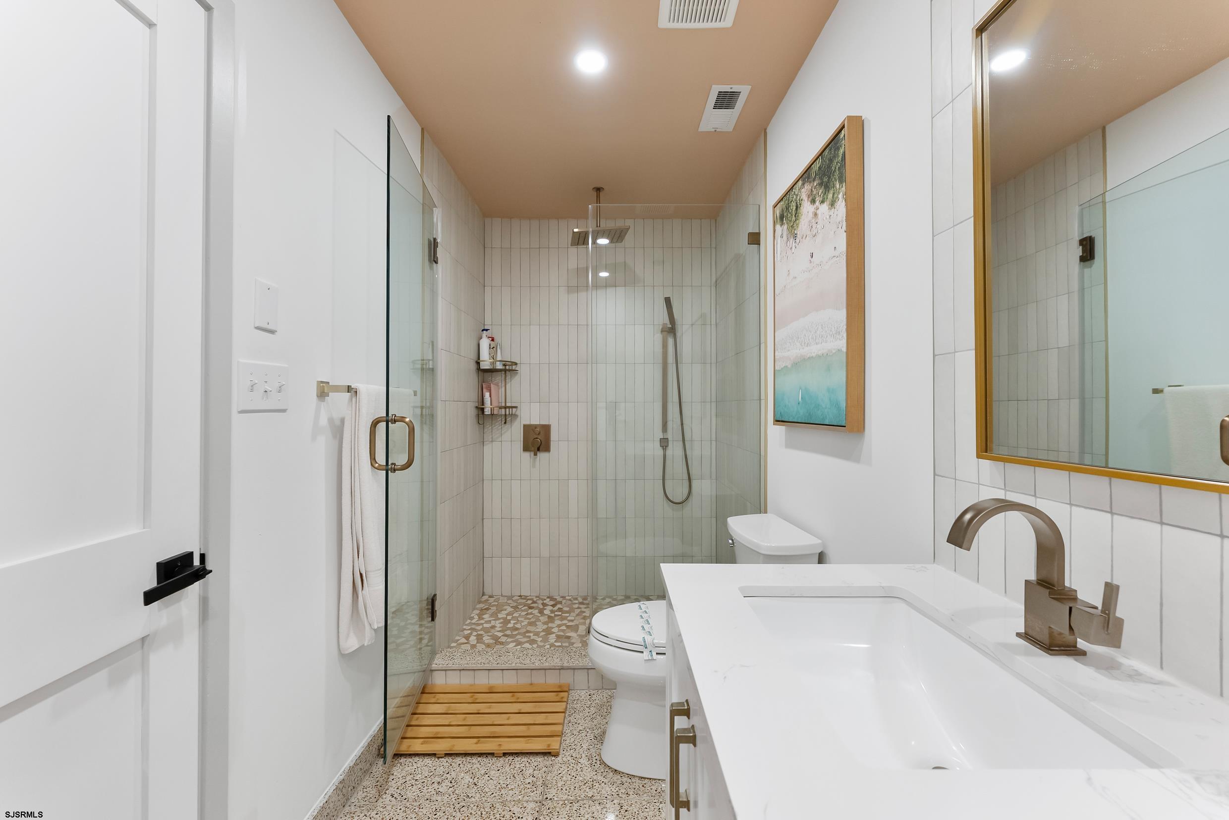 13 Delmar Drive, Unit 13 Brigantine, NJ 08203 - Photo 18 of 98 a bathroom with a sink a toilet and shower