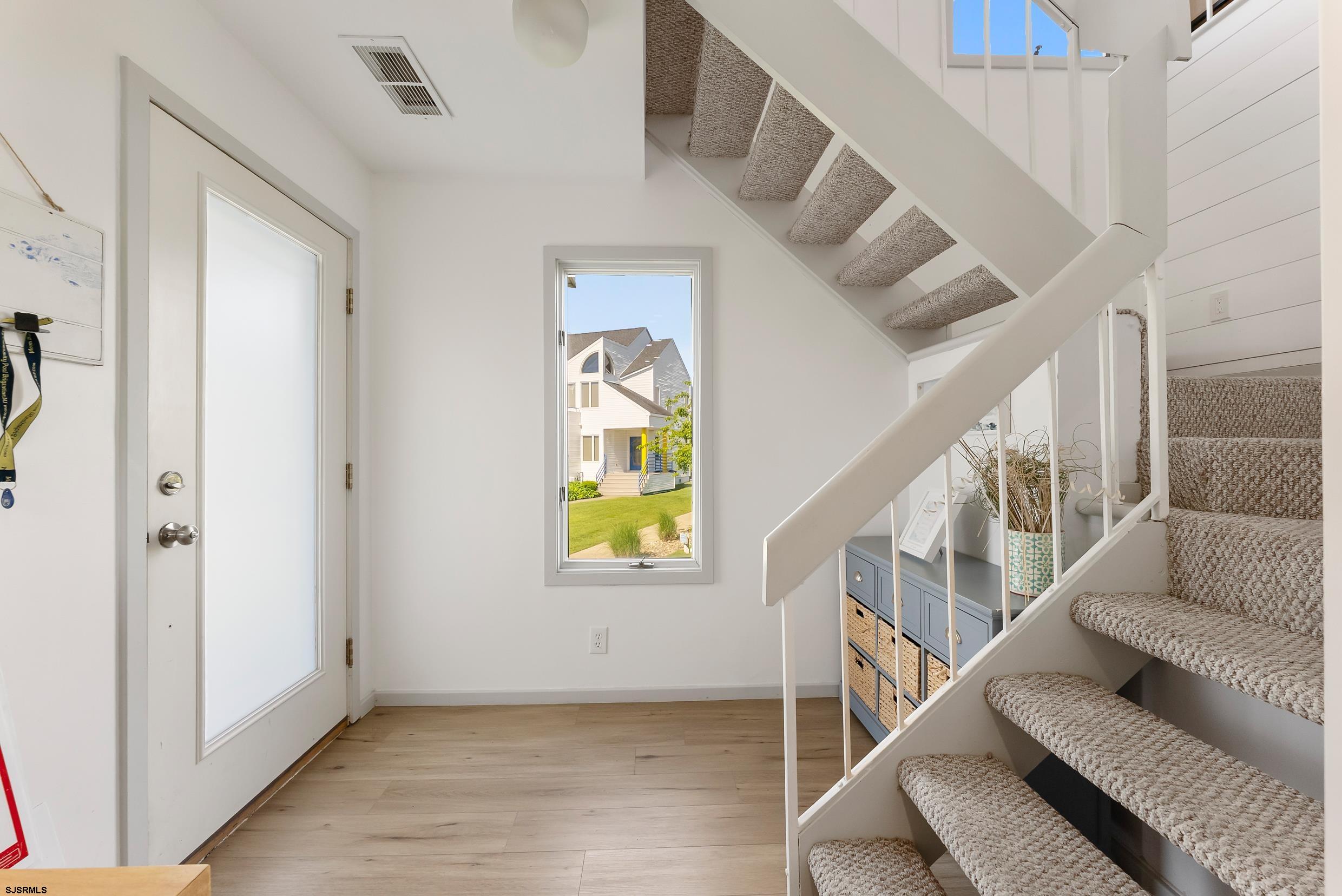 13 Delmar Drive, Unit 13 Brigantine, NJ 08203 - Photo 31 of 98 a view of entryway and hall with wooden floor