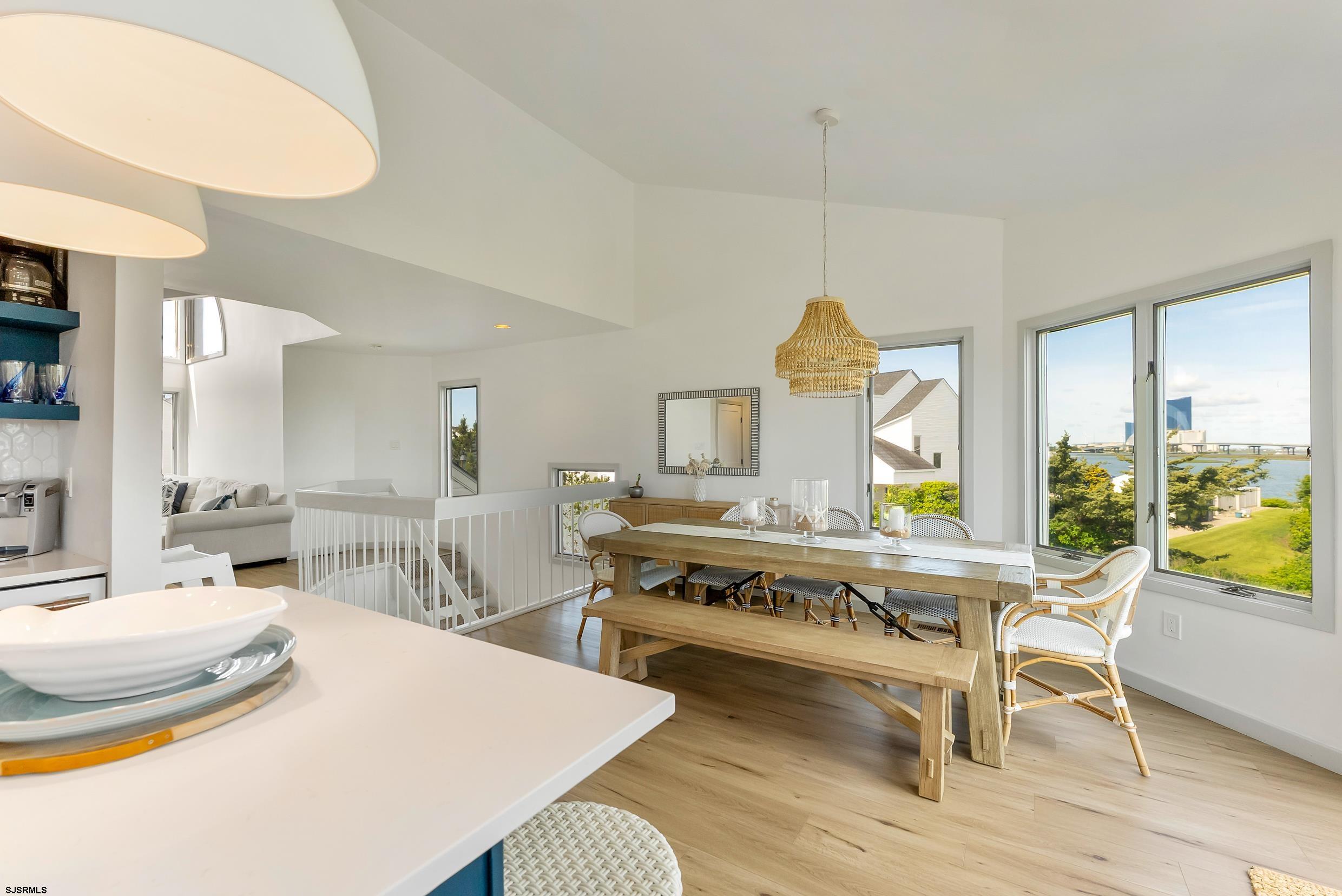 13 Delmar Drive, Unit 13 Brigantine, NJ 08203 - Photo 39 of 98 a living room with dining table and a wooden floor