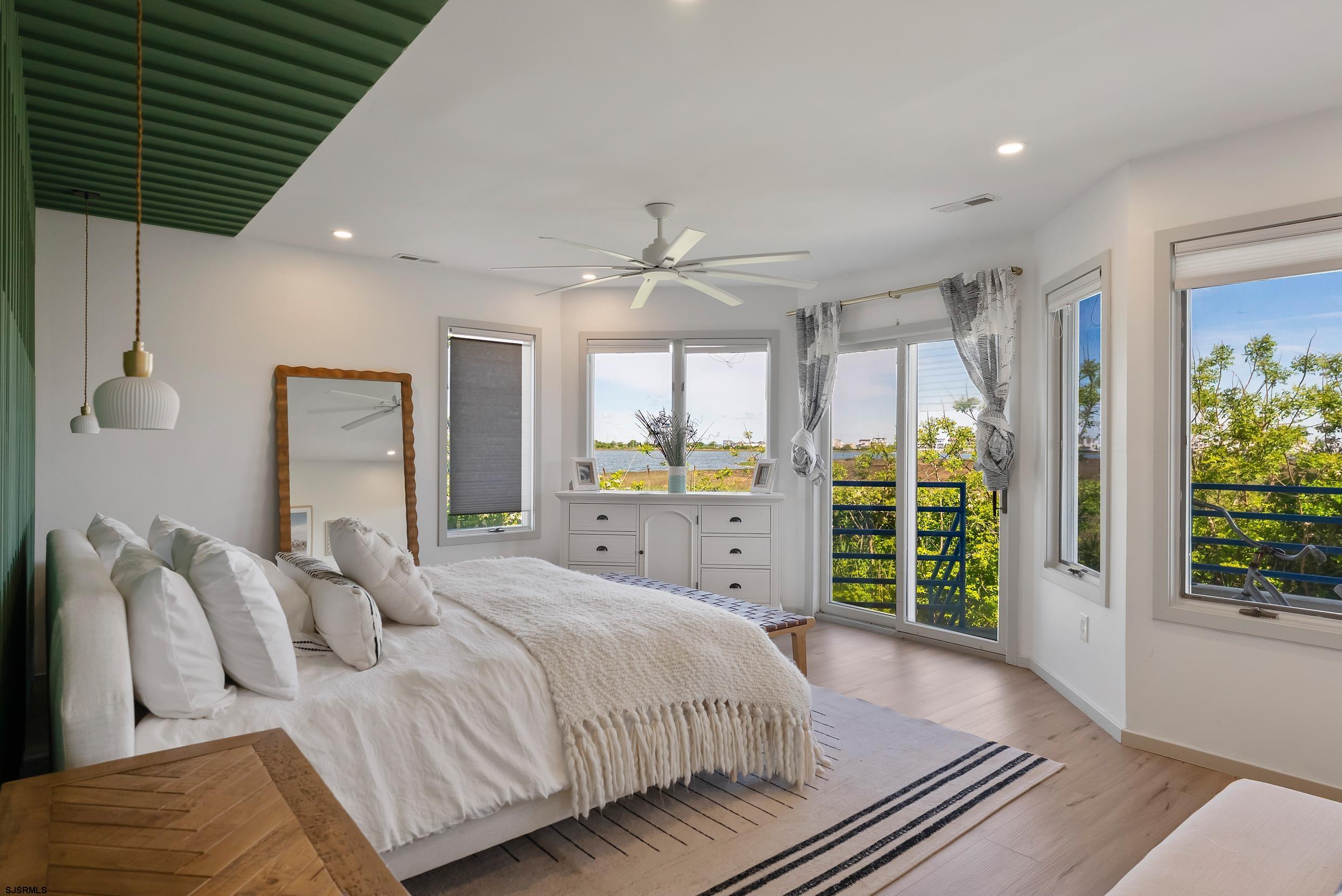 13 Delmar Drive, Unit 13 Brigantine, NJ 08203 - Photo 7 of 98 a spacious bedroom with a large bed and a large window