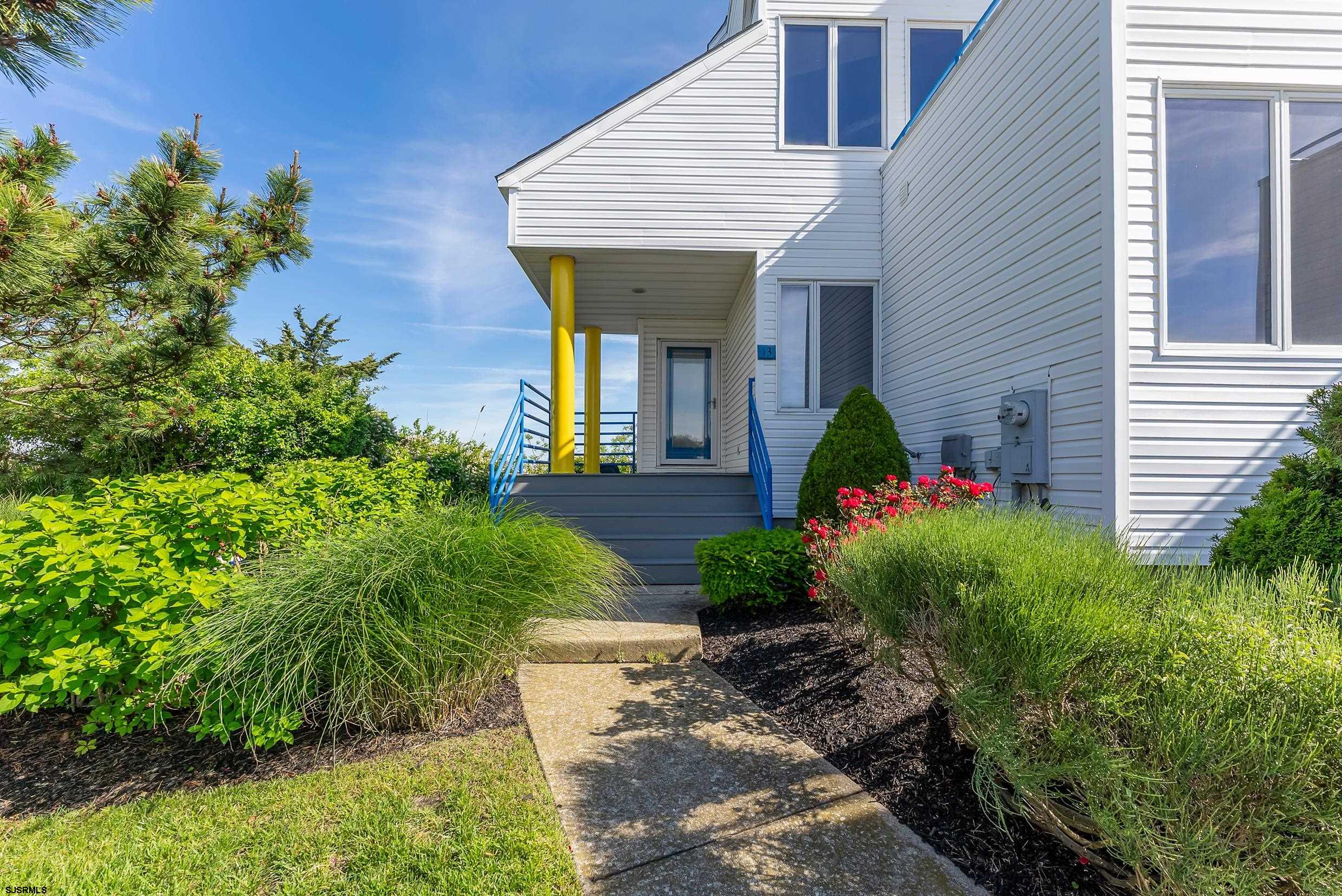 13 Delmar Drive, Unit 13 Brigantine, NJ 08203 - Photo 83 of 98 a front view of a house with a yard
