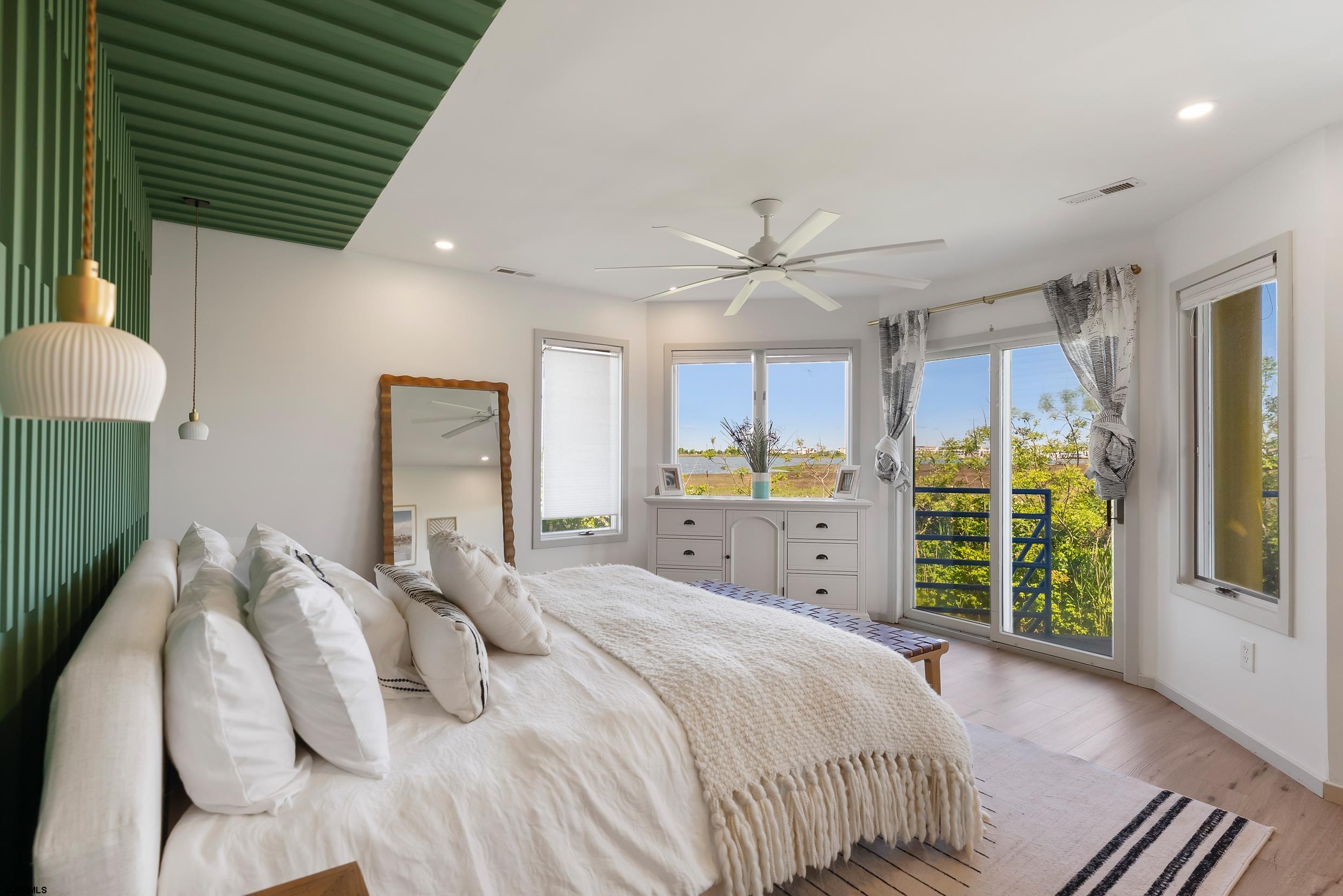 13 Delmar Drive, Unit 13 Brigantine, NJ 08203 - Photo 9 of 98 a bedroom with a large bed and a window