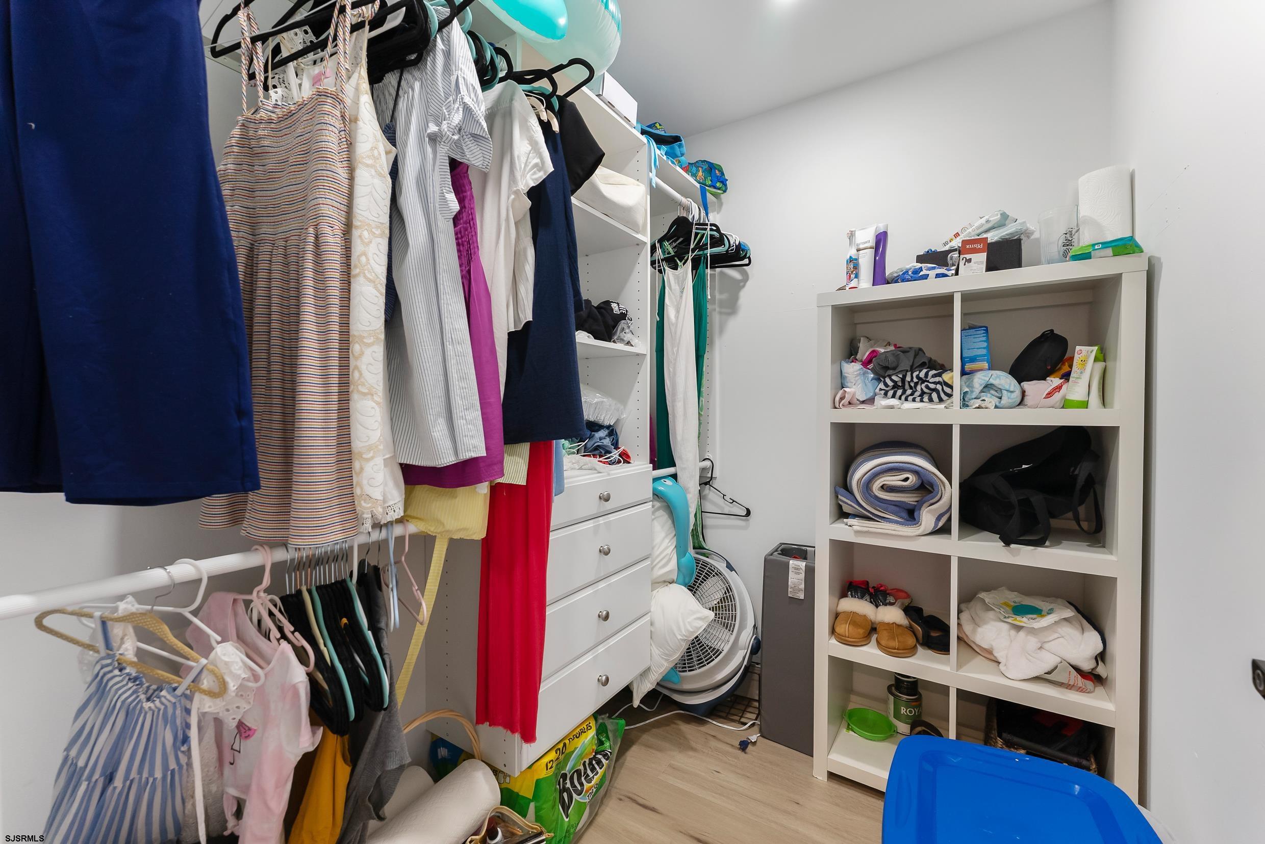 13 Delmar Drive, Unit 13 Brigantine, NJ 08203 - Photo 93 of 98 a view of walk in closet with clothes and shoes