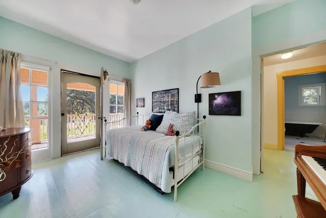 a bed sitting in a bedroom next to a window