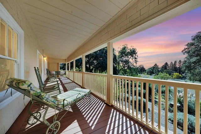 a view of balcony with wooden floor and outdoor seating