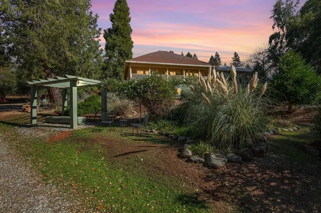 a backyard of a house with table and chairs